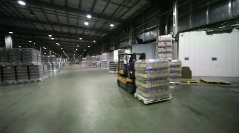 Lot of packaged beer bottles in warehouse and loader machine. Stock Footage 37656766