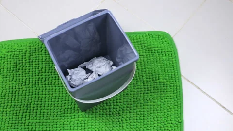 A lot of paper flies into the bin Stock Footage 102860276