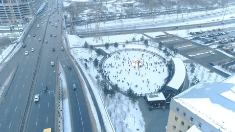 A lot of people rolling on the ice skating rink. Aerial view Stock Footage 149030285
