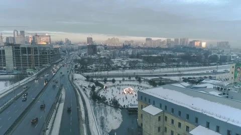 A lot of people rolling on the ice skating rink. Aerial view. Sunset Stock Footage 149030348