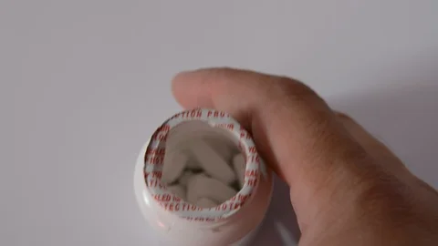 A lot of pills falls  on white background Stock Footage 113876979
