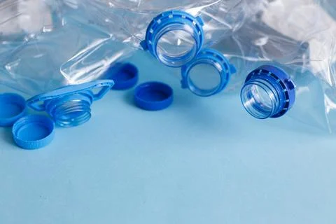 A lot of plastic empty rumpled used bottles on a blue background. waste and p Photos