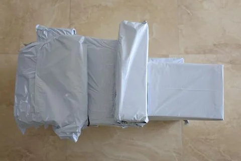 Lot of post packages in gray plastic bags Stock Photos