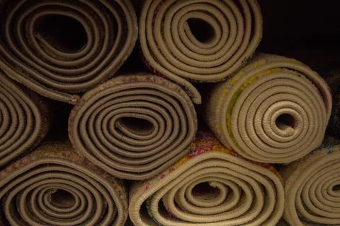 A lot of rolled-up carpets. Stock Photos