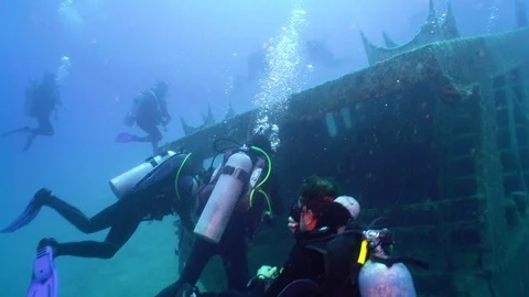 A lot of Scuba Divers Exploring a Ship Wreck Stock Footage 122198104