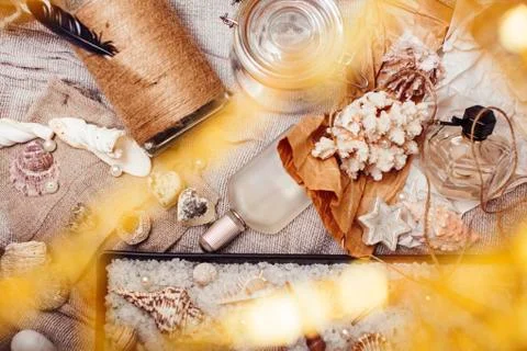 A lot of sea theme in mess like shells, candles, perfume, girl stuff on linen Stock Photos