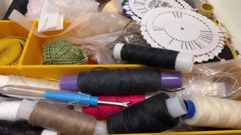A lot of sewing items such as buttons, colorful fabrics, scissors, measuring Vidéo 272691716