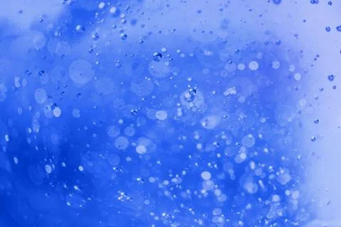 Lot of small bubbles on an blue background, macro shot of liquid soap, macro  Stock-Fotos