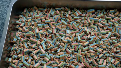 A lot of small multi-colored caramel candies in a container in a confectionery. Stock-Footage 331696827