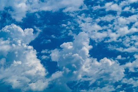 A lot of small white fluffy clouds, a background for artwork, an atmosphere.. Stock Photos