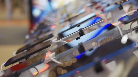 A lot of smartphone models on display at the exhibition stand of an electronics Stock Footage 263098681