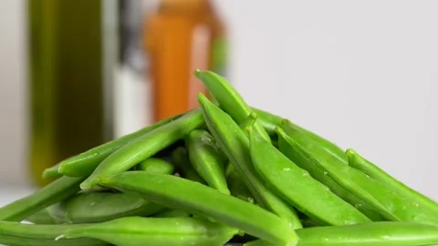 A lot of snap peas on a white background, macro, slow motion, rotation. Gro.. Stock Footage 231110526