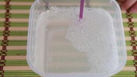 A lot of soap bubbles are blowing through the tube. Stock Footage 77588943