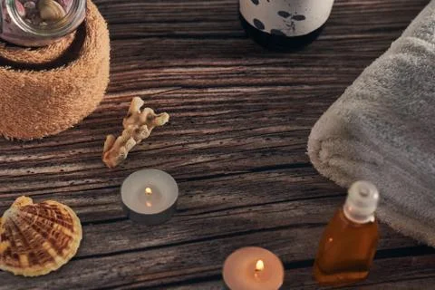 Lot of spa elements on a wooden surface, set of towels, diffuser, and candles Stock Photos