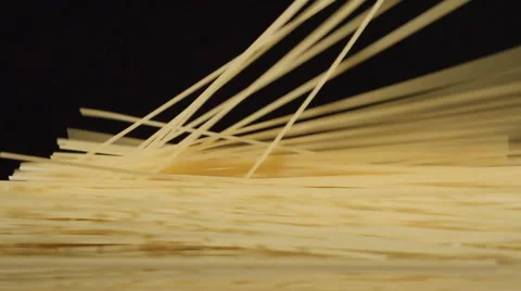 A lot of a spaghetti fall on a black background Vídeos de archivo 61033451