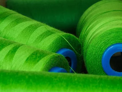 A lot of spools of green threads on the table Stock Photos
