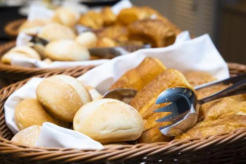 A lot of table rolls and square bread in the basket Stock Photos