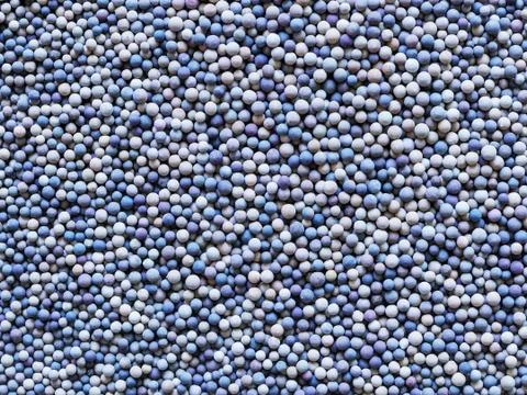 A lot of tiny ceramic balls as a textured background. Stock Photos