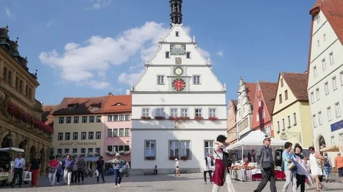 A lot of tourists walking at Main Square of historic town of Rothenburg ob der Stock Footage 80234037