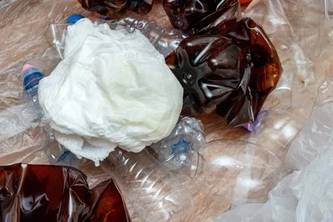 Lot of used plastic, crumpled empty bottles, packets, plastic orange dish, di Stock Photos