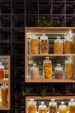 A lot of variable jars on a shelf in a modern interior with pasta, spaghetti Stock-Fotos