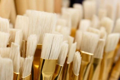 Lot of various paint brushes tool stayed close up. Selective focus. Stock Photos