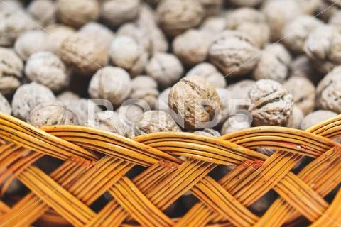 Lot of walnuts in braided basket close up Stock Photos