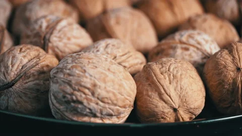 Lot of Walnuts in the Shell are Spinning on a Black Background Stock Footage 200808308