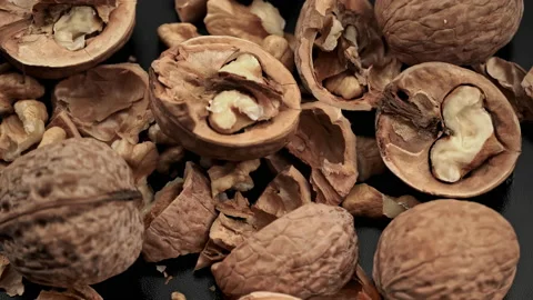 Lot of Walnuts in the Shell are Spinning on a Black Background Stock Footage 201007698