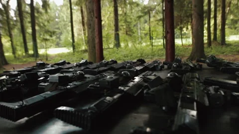 A lot of weapons on the table, preparation for the game of war. Fake guns Stock Footage 219610367