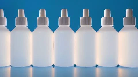A lot of white bottles with liquid. Disinfectant or medikamente in white bottles Stock Photos