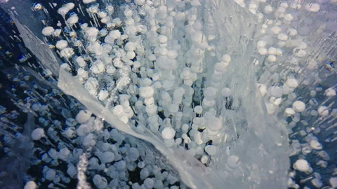 A lot of white bubbles freeze in deep blue crystalline ice at Baikal Lake. Stock Footage 165148126