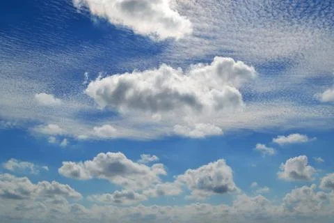 A lot of white clouds of different types high in blue sky Stock Photos