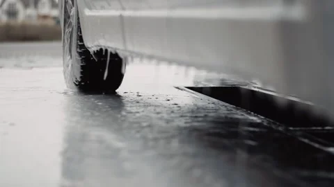 A lot of white foam drops fall from a car board on carwash Stock Footage 144674675