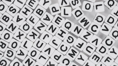 Lot of white plastic decorative cubes with alphabet letters moving randomly Stock Footage 265803938