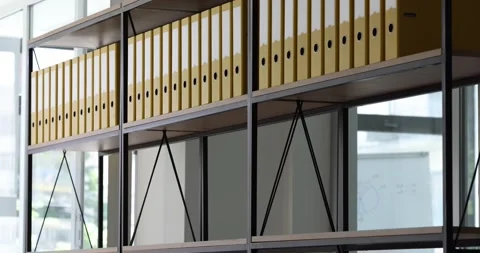 Lot of yellow folders for documents are placed on bookshelf in archive timelapse Stock Footage 240636981