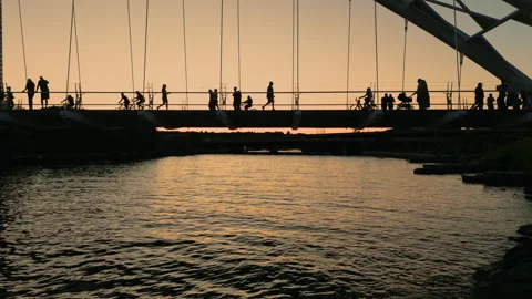 Lots of activity at sunset on Humber River bridge on a warm summer night Stock Footage 315697446