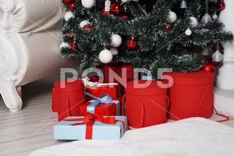 Lots of beautifull wrapped Christmas presents in round boxes in red color Stock Photos