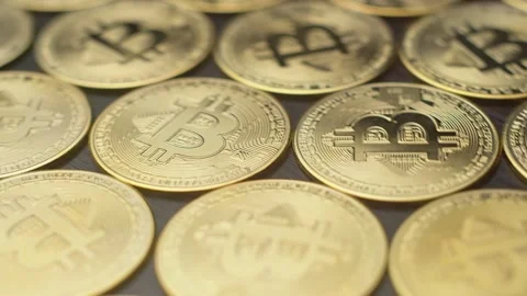 Lots of bitcoin coins are on table, rotation, closeup. Gold coins with image of Stock Footage 167544245
