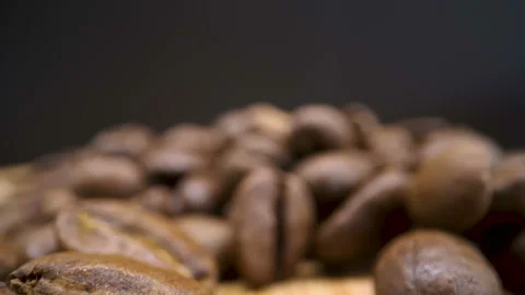 Lots of black coffee beans on top of the table Stock Footage 138537331