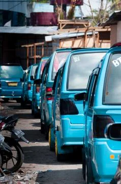 Lots of Blue transportation Vans in Queue on the street Stock Photos