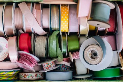 Lots of bright colored ribbons for packaging or bouquets. Gift and flower shop Фото