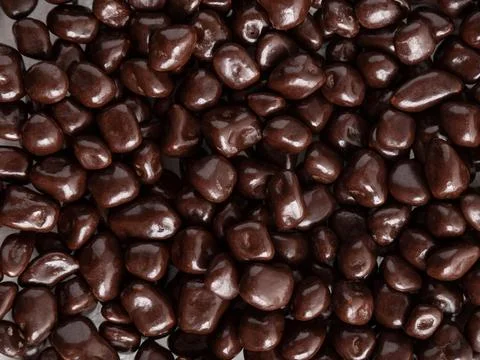 Lots of brown chocolates. Background, texture, lots of sweets. Stock Photos