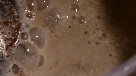 Lots of bubbles in a cocktail. Close-up of mixer whipping milk smoothie with Stock Footage 84022787