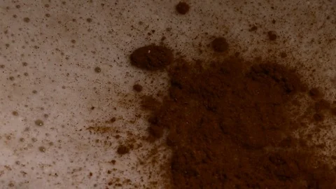 Lots of bubbles in a cocktail. Close-up of mixer whipping milk smoothie with Stock Footage 84023201