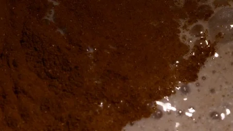 Lots of bubbles in a cocktail. Close-up of mixer whipping milk smoothie with Stock Footage 84023790