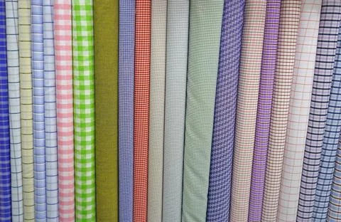 Lots of bundles of different varieties of new fabric in many color. Stock Photos