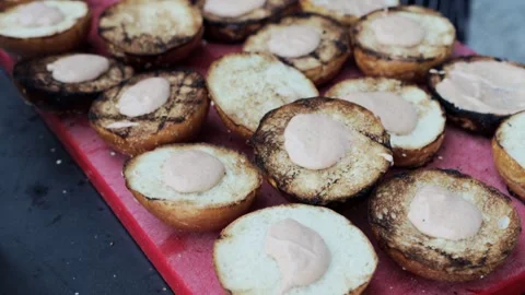 Lots of burger buns with sauce on the table, slow motion Stock Footage 314428211