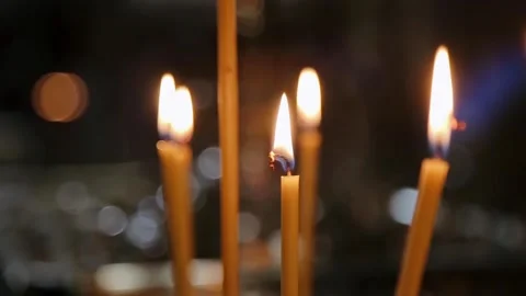 Lots of candles are burning in the Temple. Close up of many candles in an Stock Footage 151417997