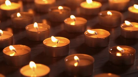 Lots of candles burning on flat surface Видео 181656264